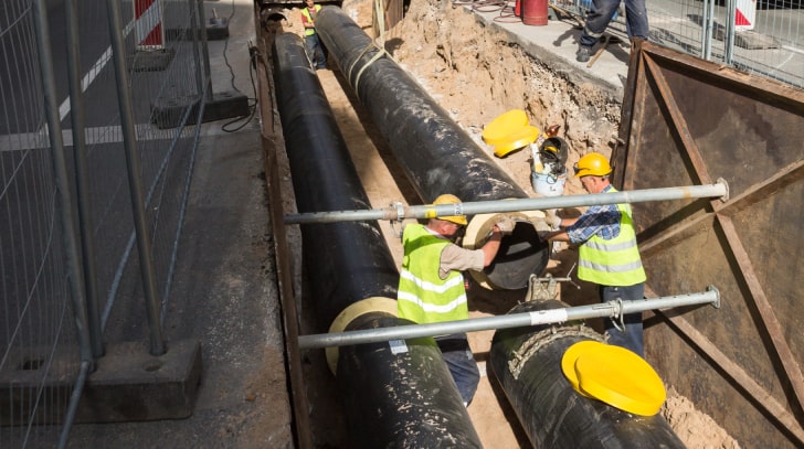 Workers connecting two Water Pipes